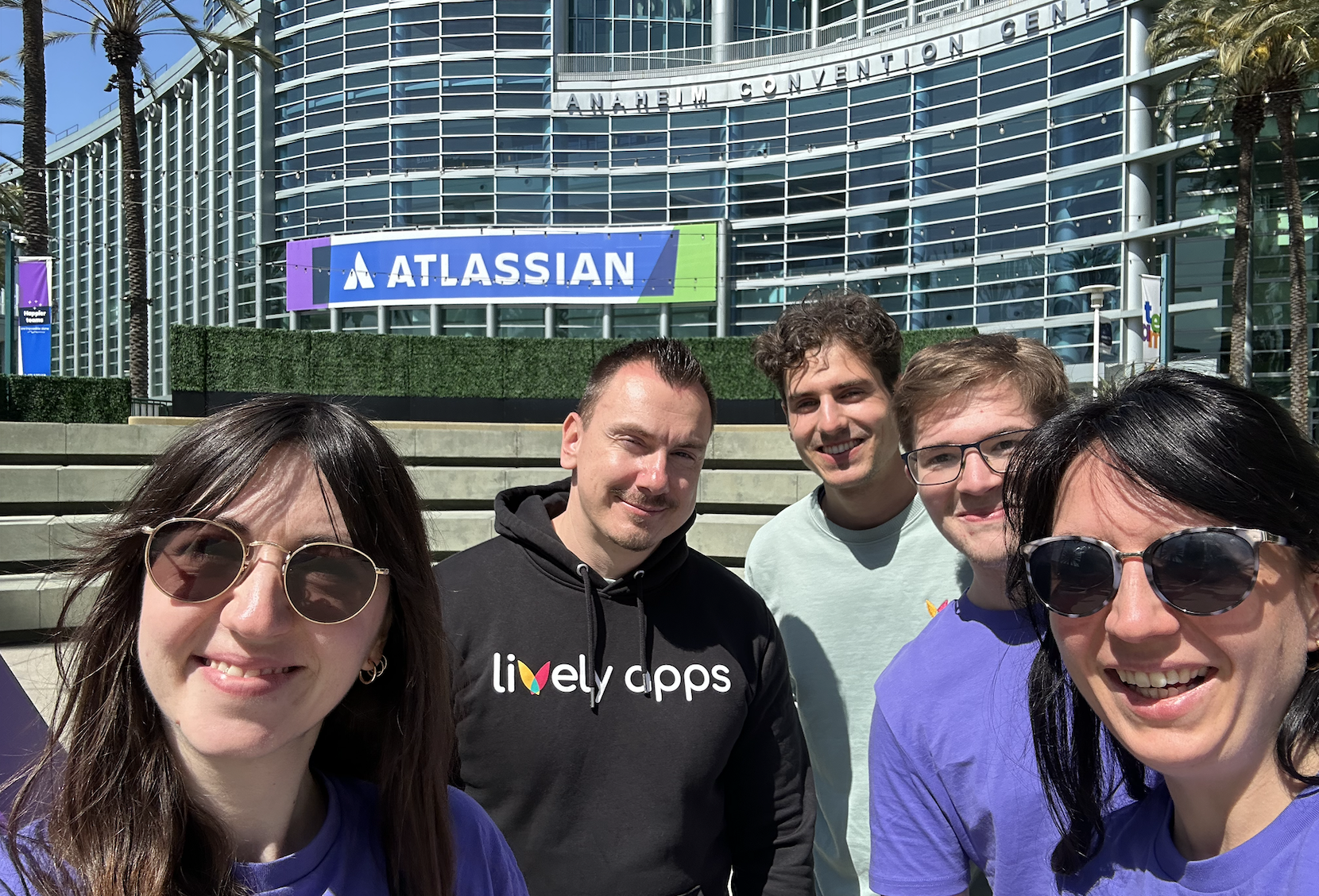 The Lively Apps team smiling outside the Atlassian Convention Center in Anaheim.